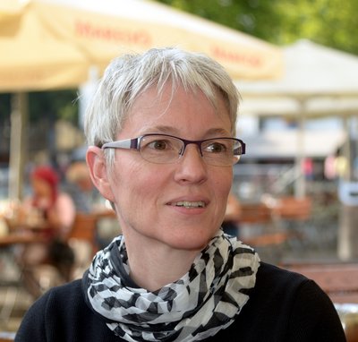 Eine Frau mit Brille und kurzen grauen Haaren